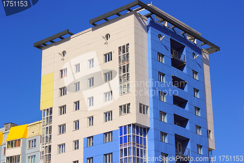 Image of The inhabited high house against the blue sky