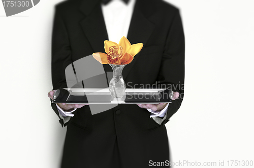 Image of Waiter holding flower on silver tray