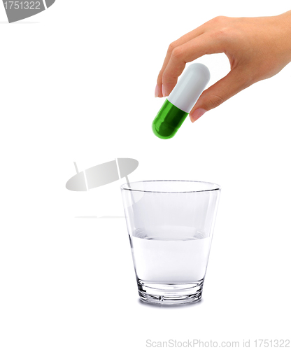 Image of Hand and big pill with glass water - concept