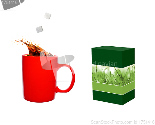 Image of Hot cup of tea and sugar cubes and tea box
