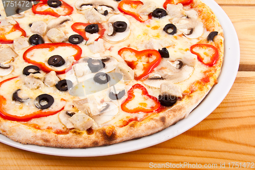 Image of pizza with red pepper and mushrooms