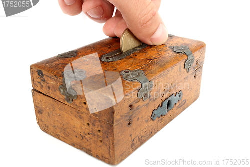 Image of putting a coin in moneybox