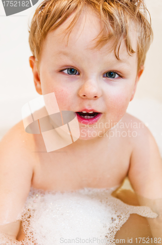 Image of The little boy bathes in bathing with foam