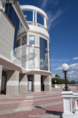 Image of Glass facade and balcony with columns.