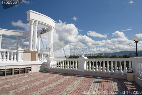 Image of Arch with white columns and balustrade.