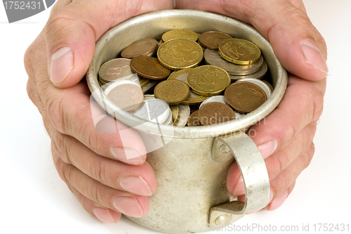 Image of Old aluminum mug and coins.