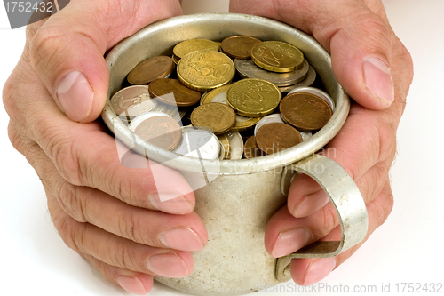 Image of Old aluminum mug and coins.
