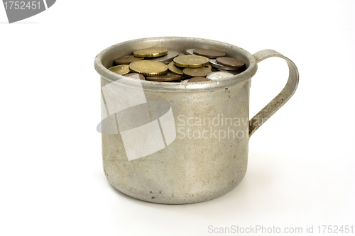 Image of Old aluminum mug and coins.