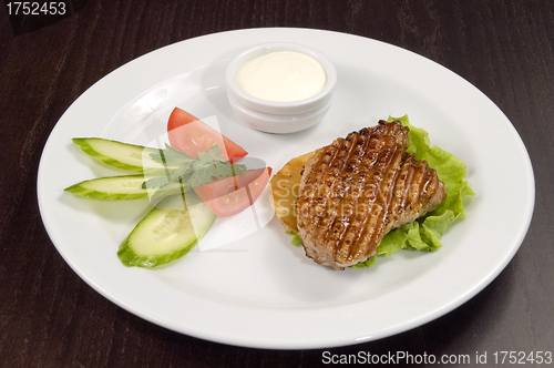 Image of Piece of fried meat with vegetables.