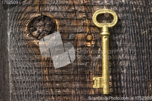 Image of Old key of gold colour.