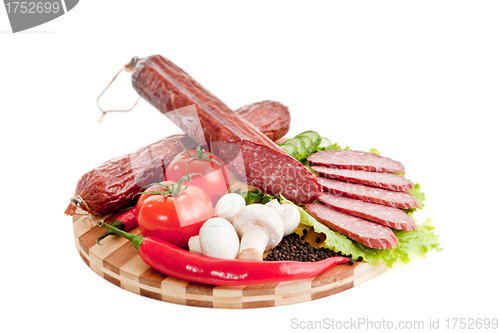Image of sliced sausage with vegetables and red papper