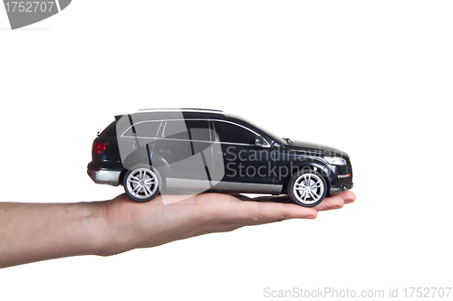 Image of man holding a toy car
