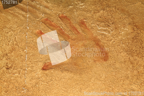 Image of Red hand print on stone