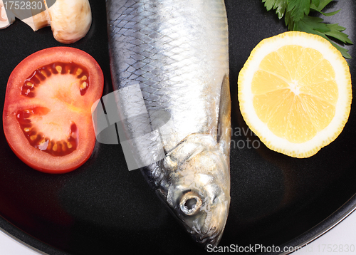 Image of fish in pan with vegetables