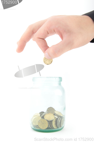 Image of coin dropping in glass jar