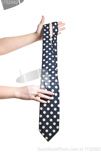Image of man holding polka dot tie