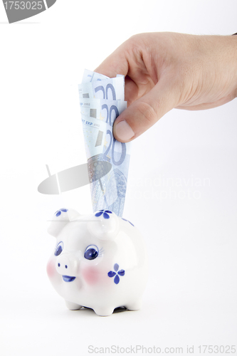 Image of hand euro with piggy bank