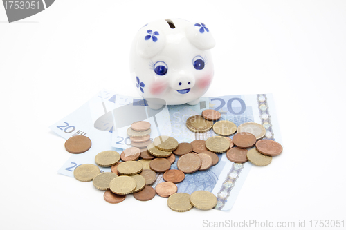 Image of coins and euro with piggy bank