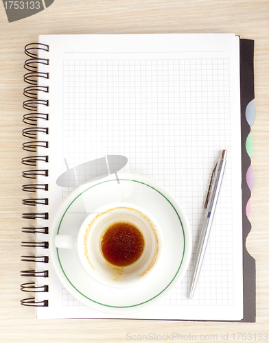 Image of blank page, empty cup of coffe, pen