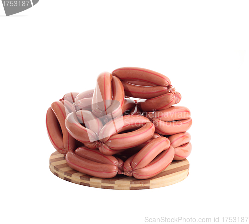 Image of sausages on wooden plate