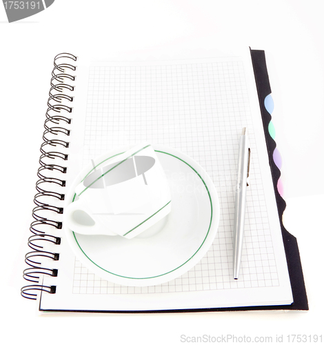 Image of Coffee and pen on notebook isolated