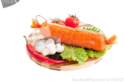 Image of sliced sausage with vegetables and red papper