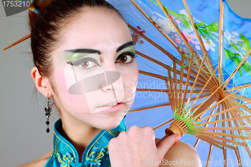 Image of Young beautiful china girl with umbrella