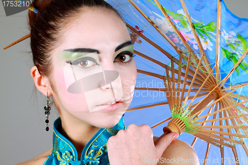 Image of Young beautiful china girl with umbrella