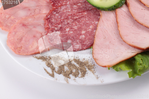 Image of various sliced sausages with vegetables
