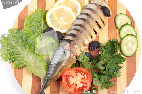 Image of sliced herring on wooden plate