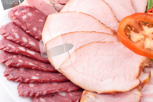 Image of various sliced sausages with vegetables