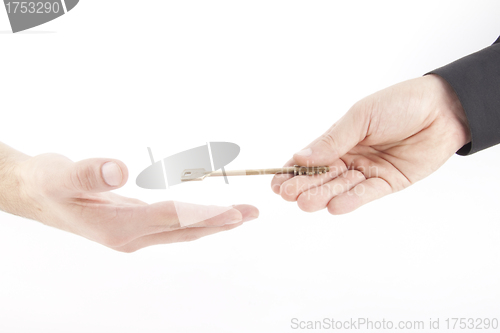 Image of Male hand holding golden key