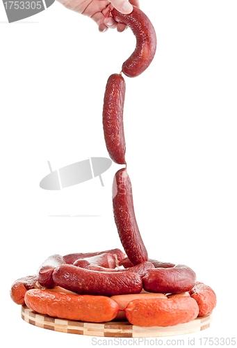Image of Sausages in hands on a white background