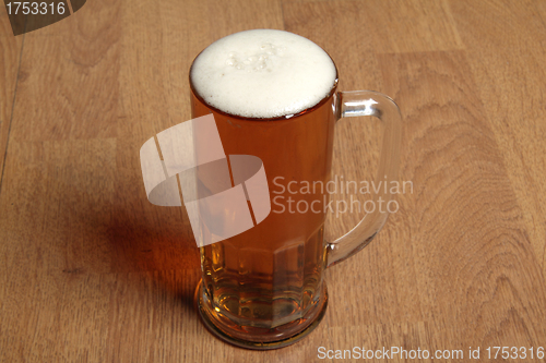 Image of Single beer glass on wooden table