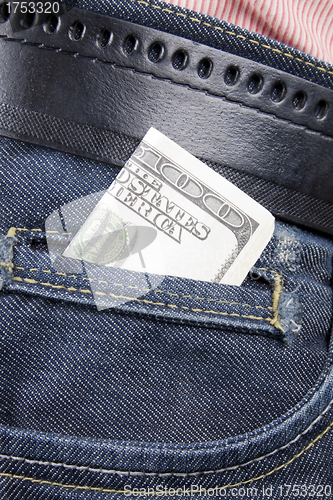 Image of Stack of dollar bills in jeans pocket