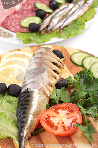 Image of sliced herring on wooden plate