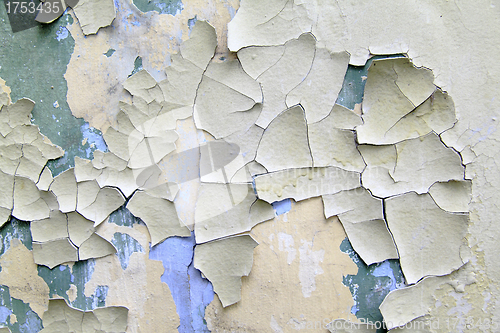 Image of Old paint peeling from wall close up