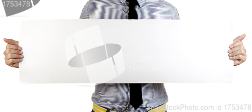 Image of Businessman holding a blank sign in front of him