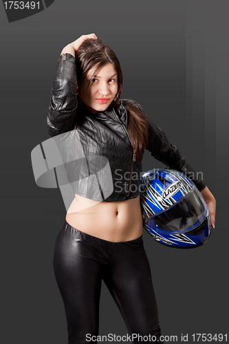 Image of Sexy brunette biker holding her helmet
