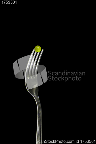 Image of Fresh green peas on a silver fork
