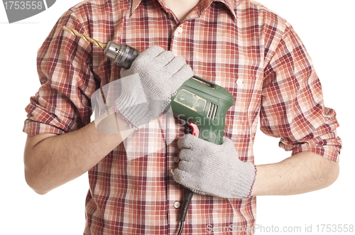 Image of hands handling an electric drilling machine