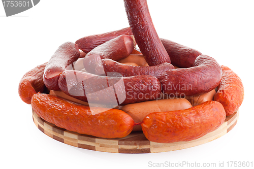 Image of various sausages on wooden plate