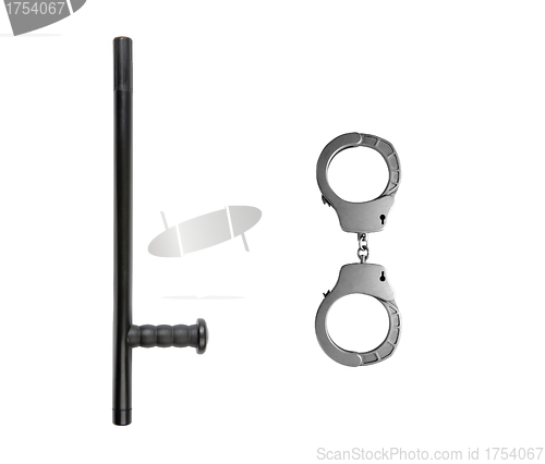 Image of Rubber baton lying and handcuffs on a white background