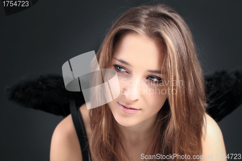 Image of young beautiful girl with black wing