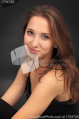 Image of beautiful young girl smiling, on gray background