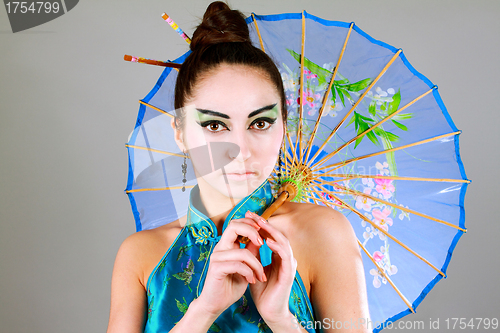 Image of Young beautiful china girl with umbrella