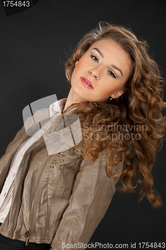 Image of portrait of girl in brown jacket on black background