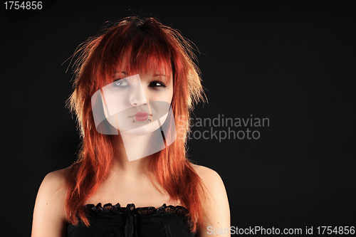 Image of Attractive girl with red hair on a black background