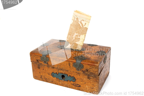 Image of new money in old moneybox