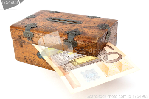 Image of money partly in wooden box